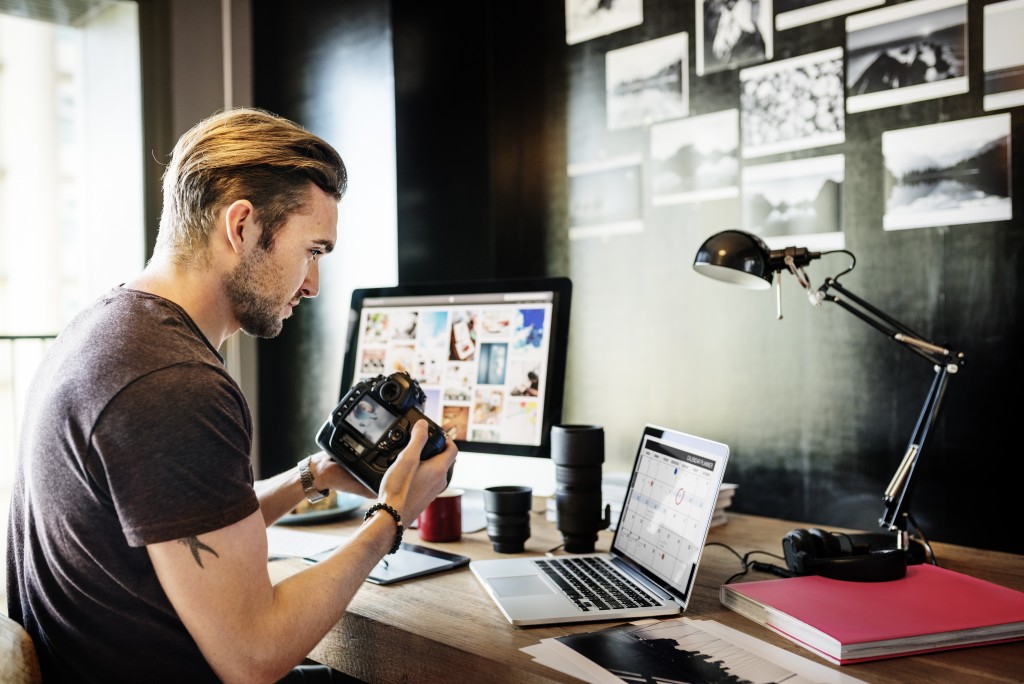 Freelance photographer checking his shots