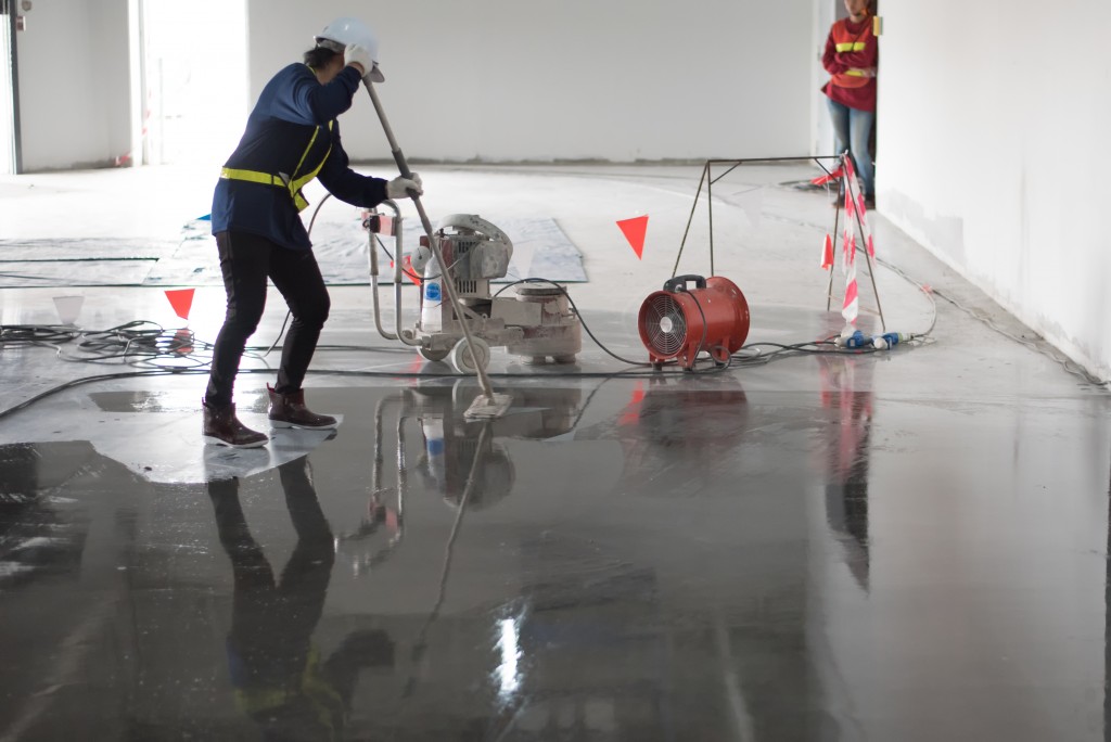 workers applying epoxy coating on the floor