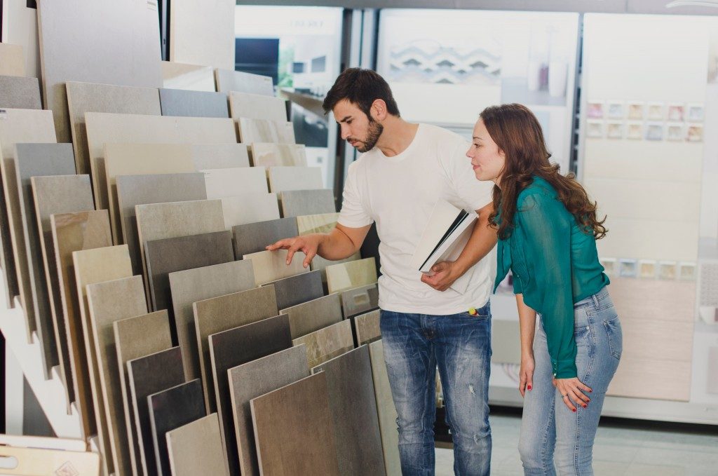 couple looking at floor tile designs