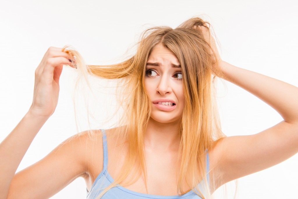 Looking at her damaged hair