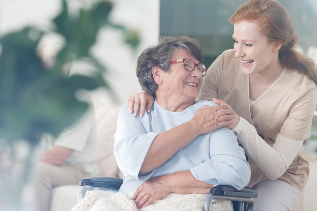 Elderly woman with her caregiver