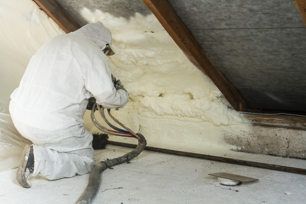 Worker insulating the attic