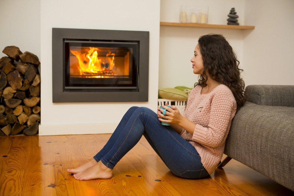 Girl sitting by the fire