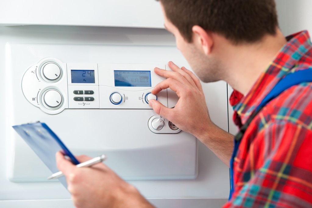 man adjusting home heating system