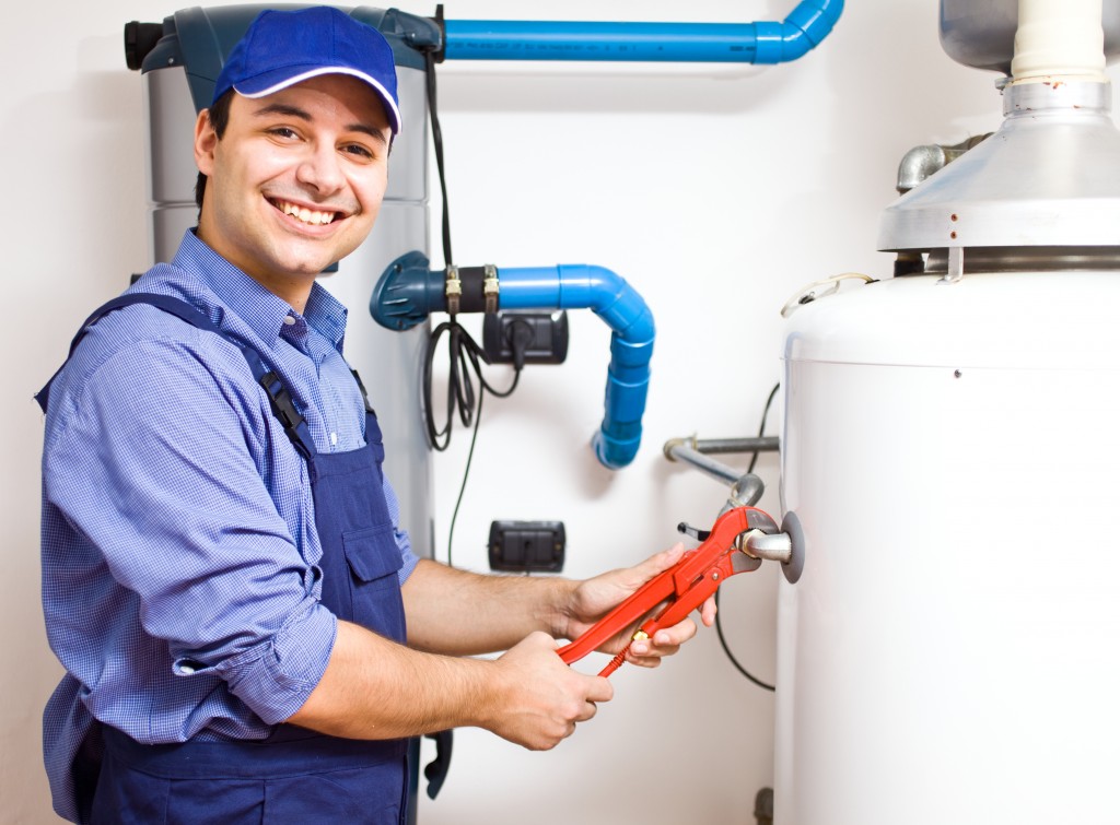 man fixing the heater