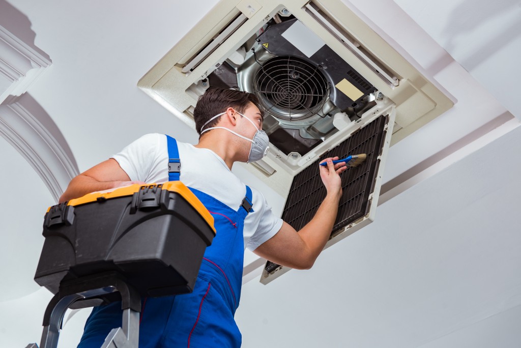 man checking the air conditioner