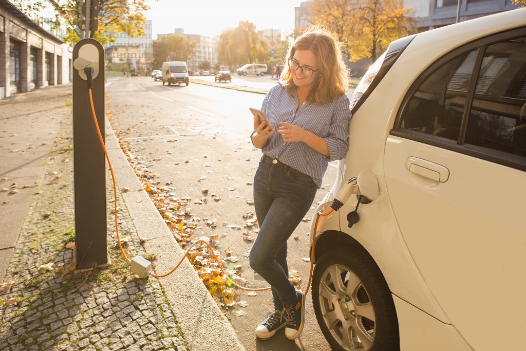 woman leaning on her car