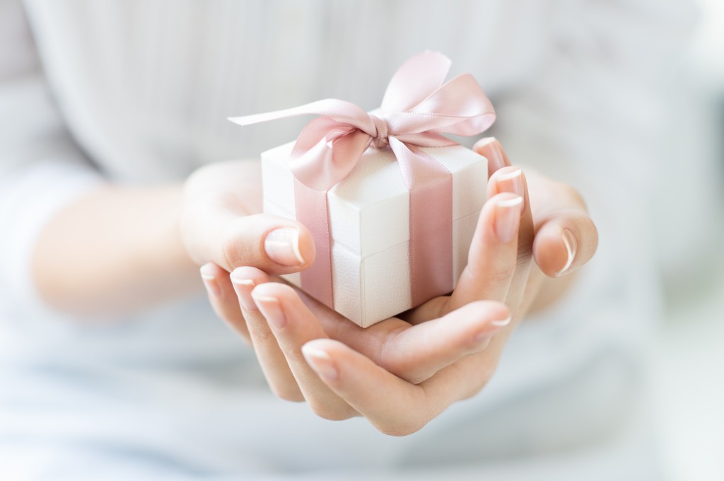 person holding a small gift box