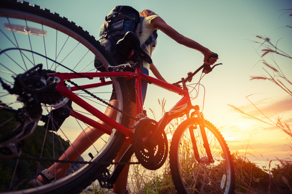 Hiker with bicycle watching sunset