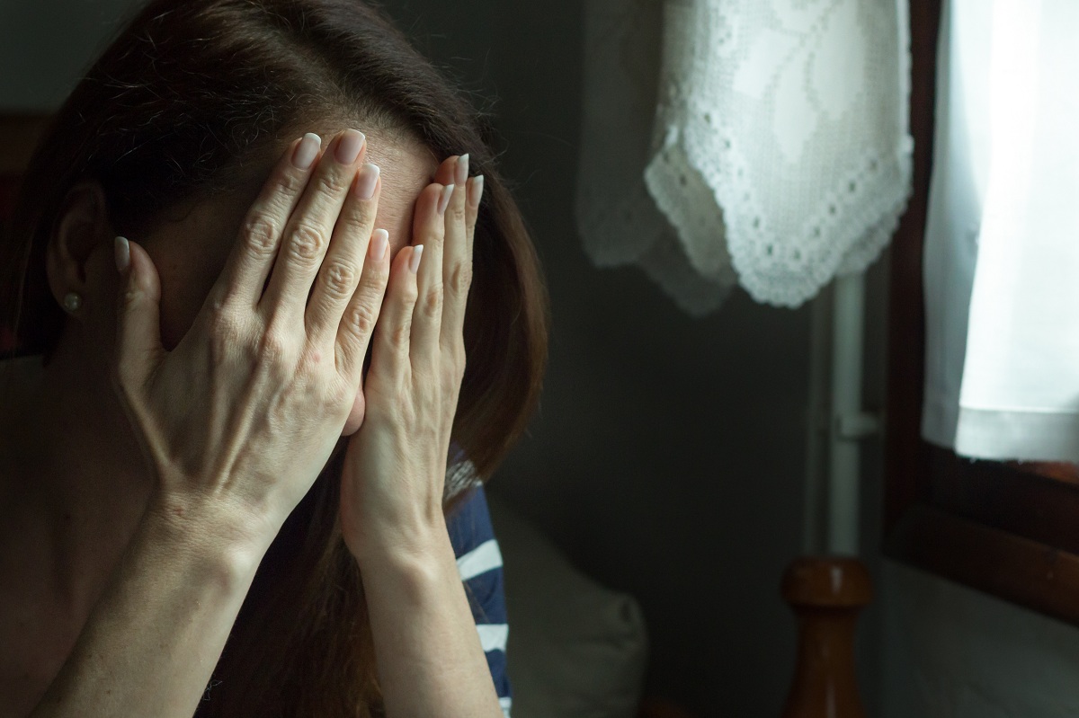 woman covering her face