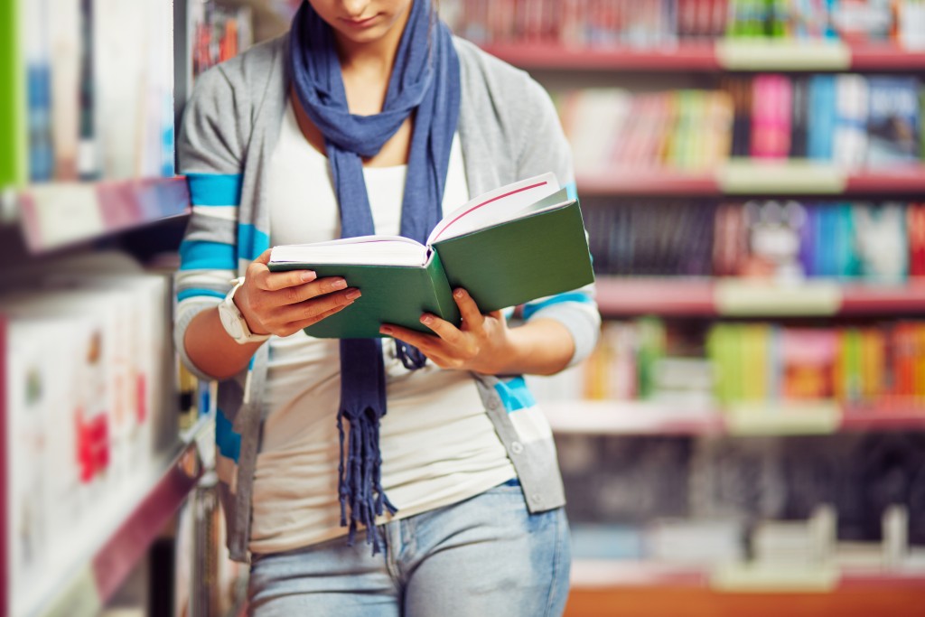 woman reading book in the library