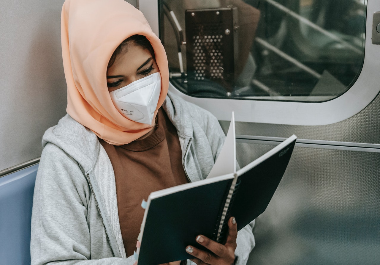 woman reading a book on the train