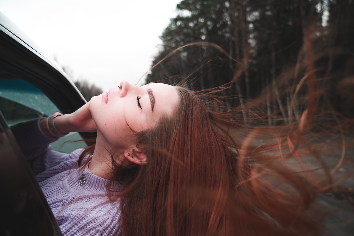 woman with her head out the window