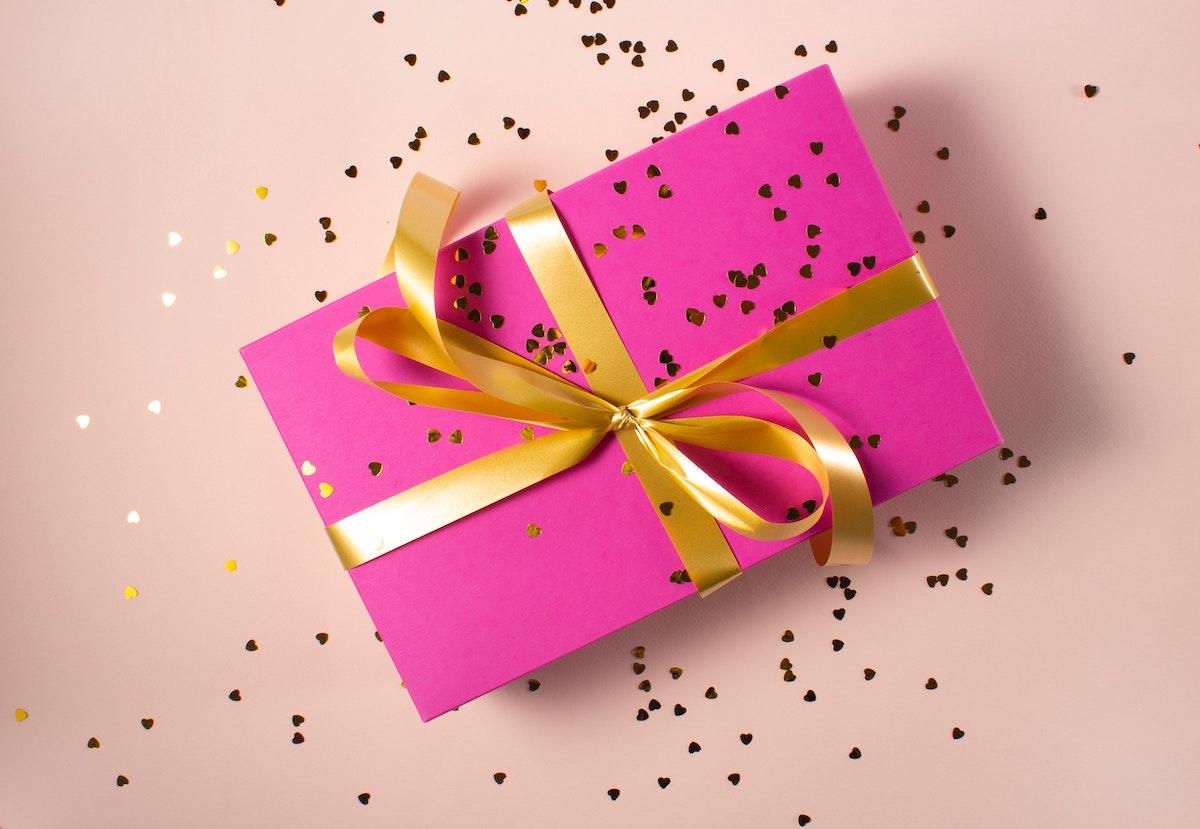 pink gift wrap with gold ribbon