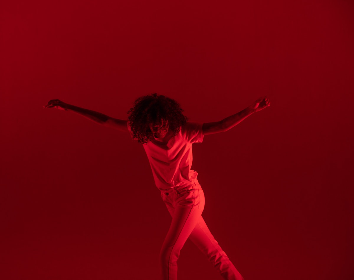 person dancing under the red lights