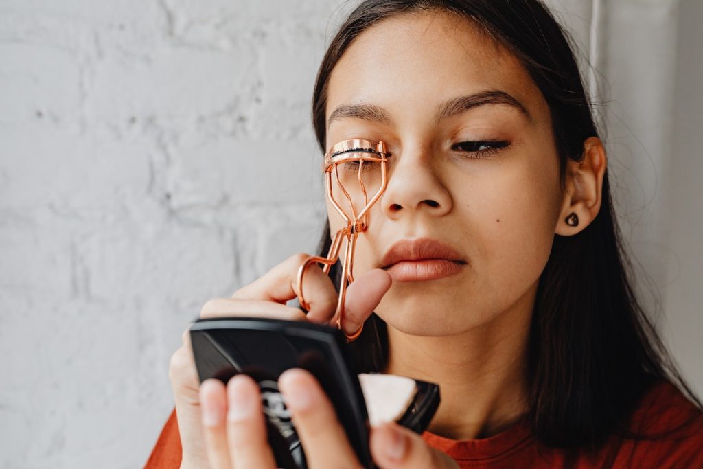 woman styling her eyelashes