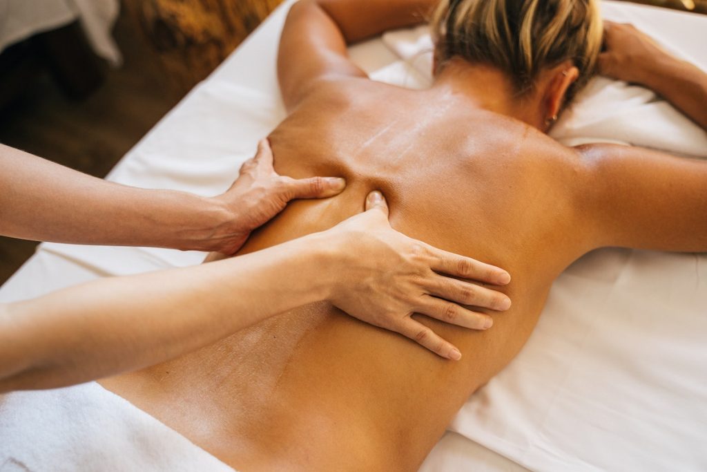 a woman being massaged by a masseuse's hands