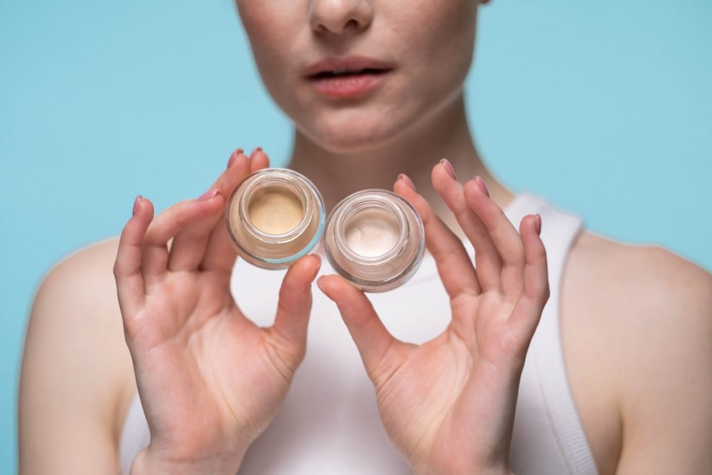 a woman holding a concealer