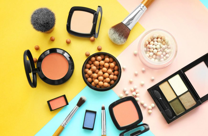 collection of face makeup in a brightly colored surface