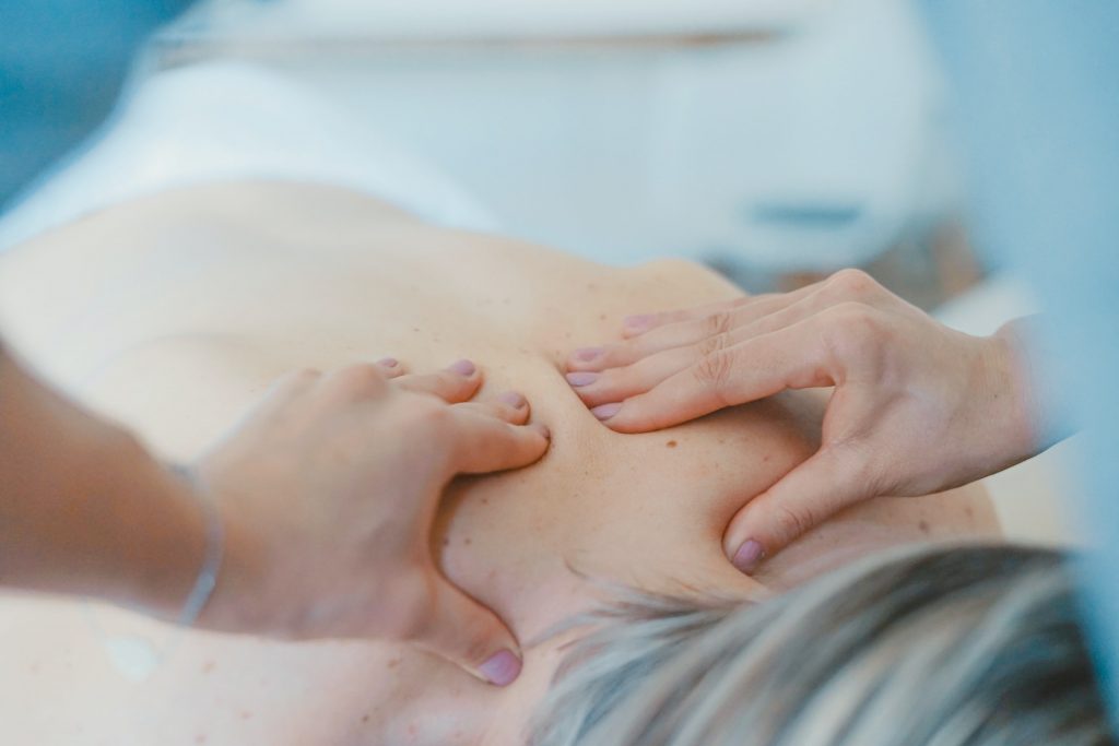 massaging the back of a woman